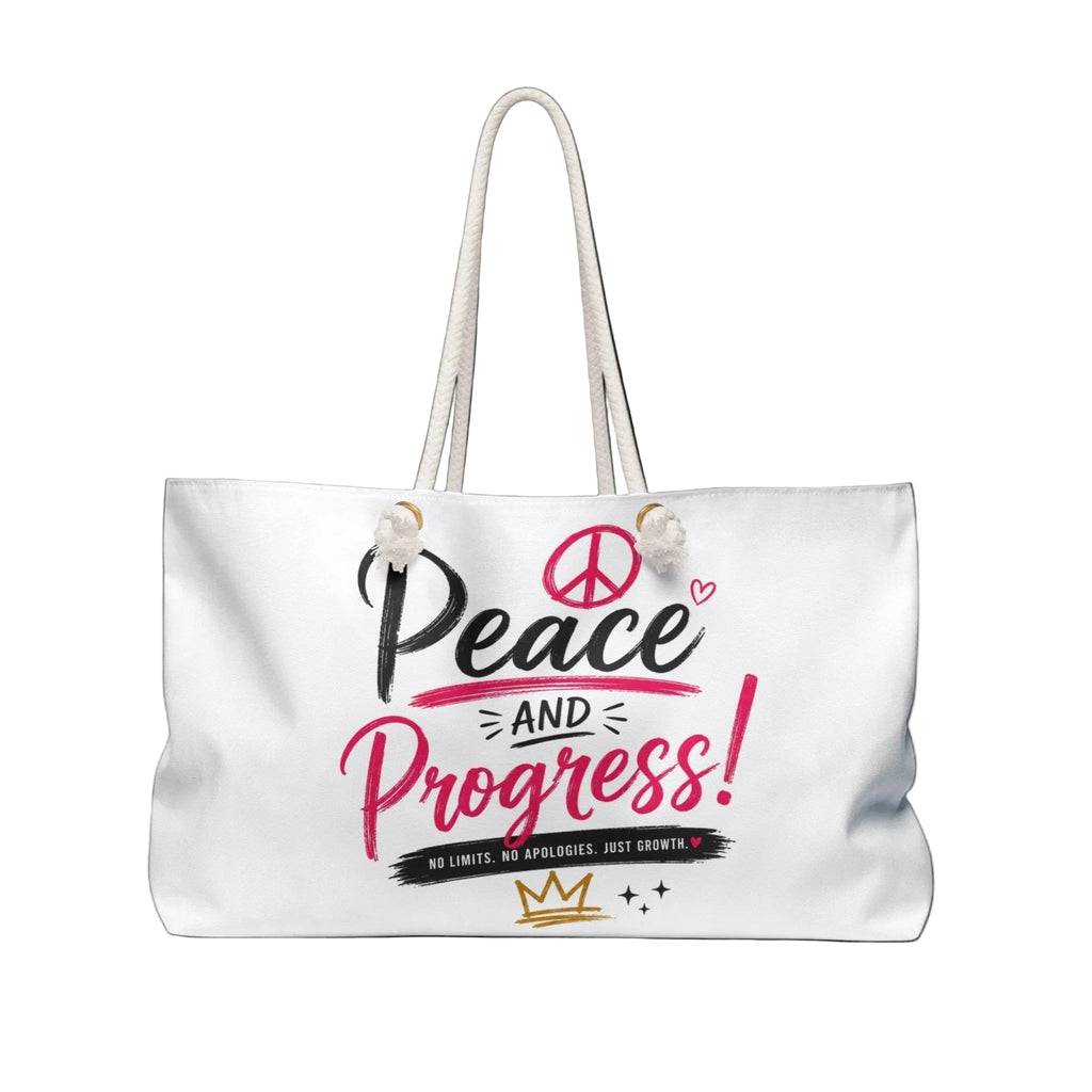A white canvas tote bag with white rope handles, featuring a graphic print on the front that reads 'Peace and Progress!' in black and pink lettering, with a peace sign, small heart, and a gold crown.