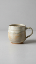 Ceramic tea mug with hand-carved texture
