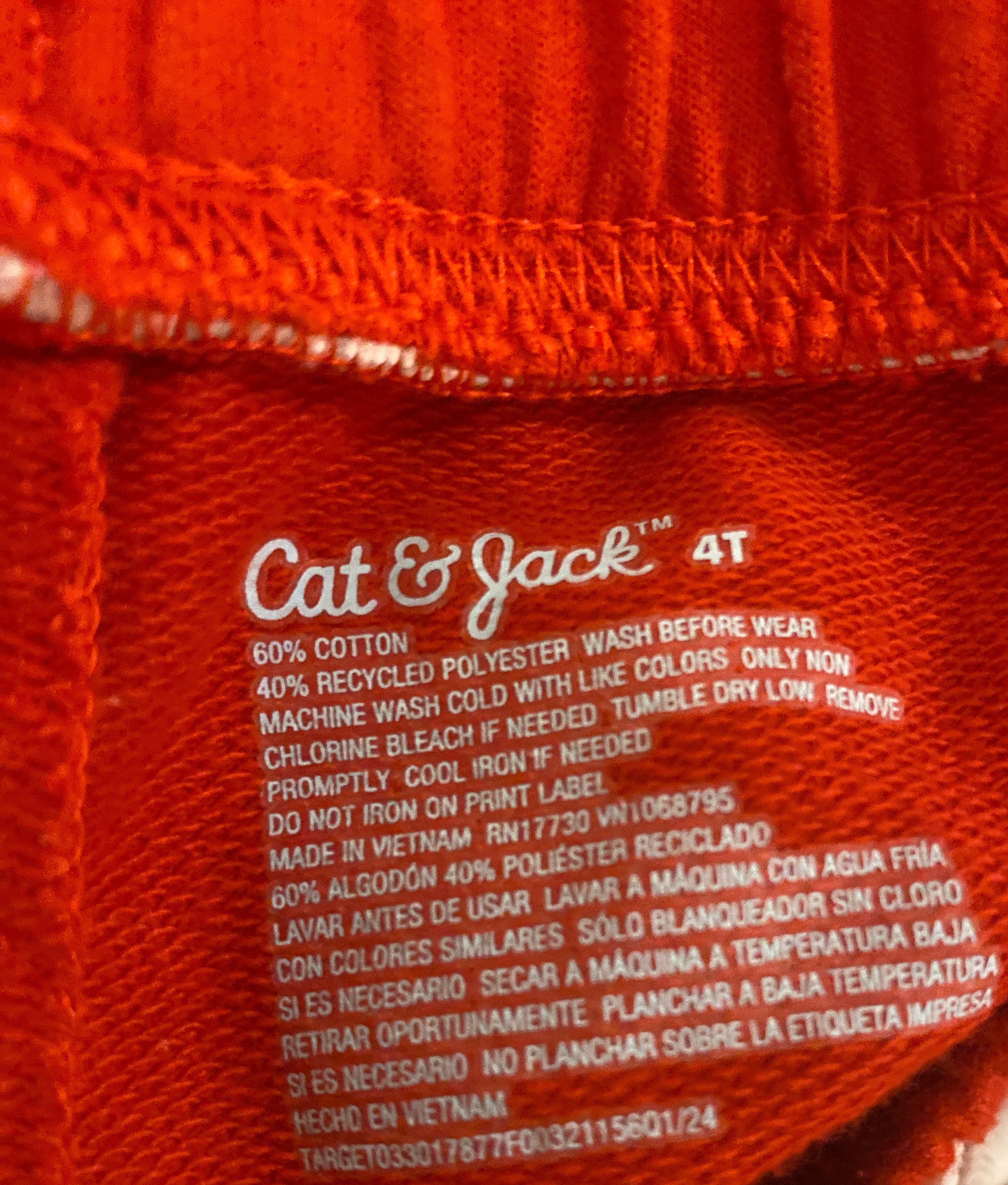 Cat & Jack shorts interior tag showing size 4T, 60% cotton 40% recycled polyester, made in Vietnam