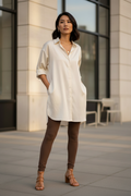 Asian woman wearing cream satin shirt with brown leggings and sandals