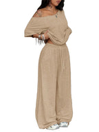 Woman wearing a beige off-shoulder top and wide-leg pants with text '2 Pack' on a white background.