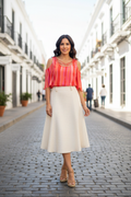 Latina woman wearing coral stripe cold-shoulder top with skirt