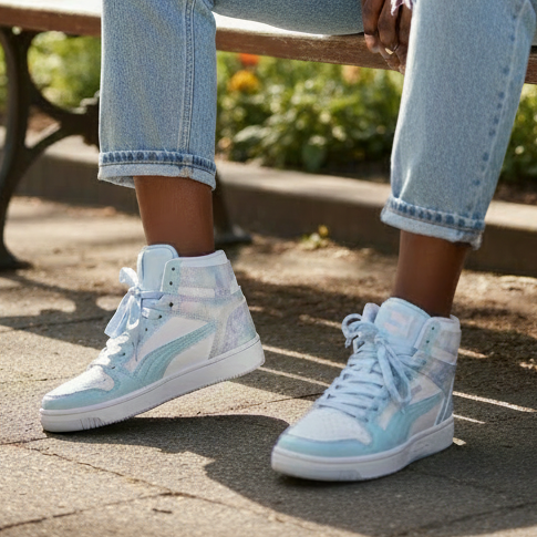 Young woman with braids wearing Puma iridescent high-top sneakers