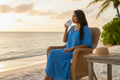 Woman in Blue Kaftan Drinking Coffee